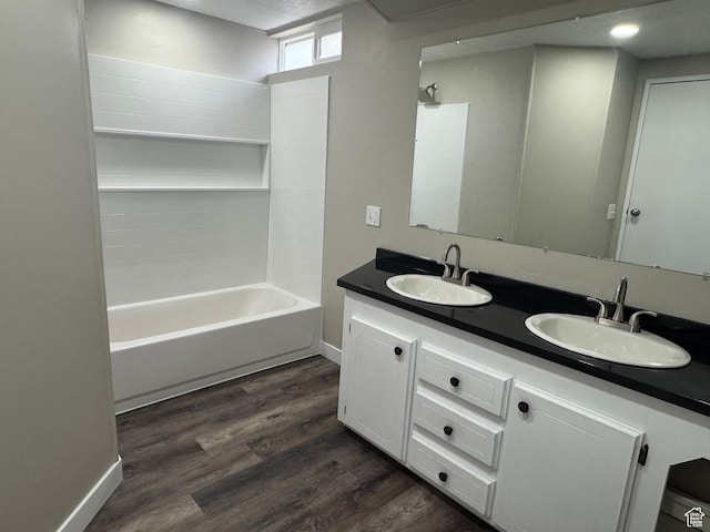 22 S 400 E, Myton, UT 84052 - full bath featuring wood finished floors, double vanity, baseboards, and tub / shower combination