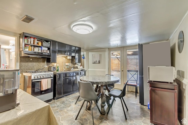 458 N Erie St W, Salt Lake City, UT 84116 - kitchen featuring appliances with stainless steel finishes, under cabinet range hood, backsplash, light stone finish floors, and light countertops