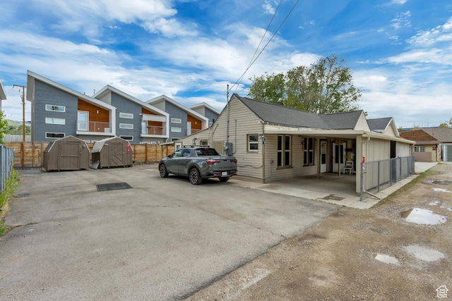 458 N Erie St W, Salt Lake City, UT 84116 - back of house featuring a shed, an outdoor structure, and a gate