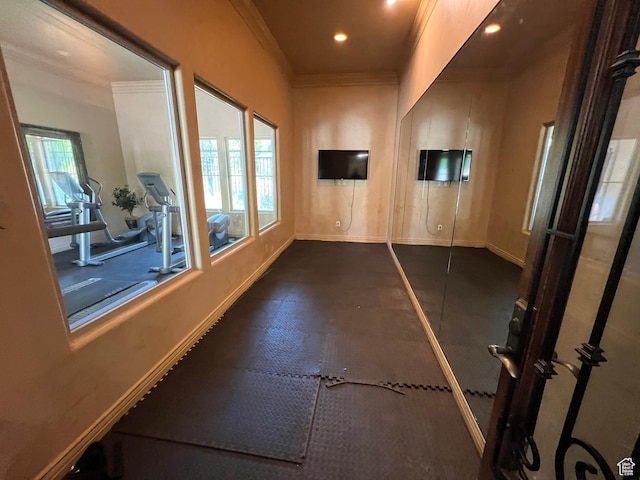 hall featuring baseboards, ornamental molding, and recessed lighting