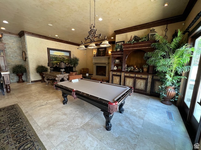 rec room featuring healthy amount of natural light, crown molding, billiards table, recessed lighting, and a fireplace