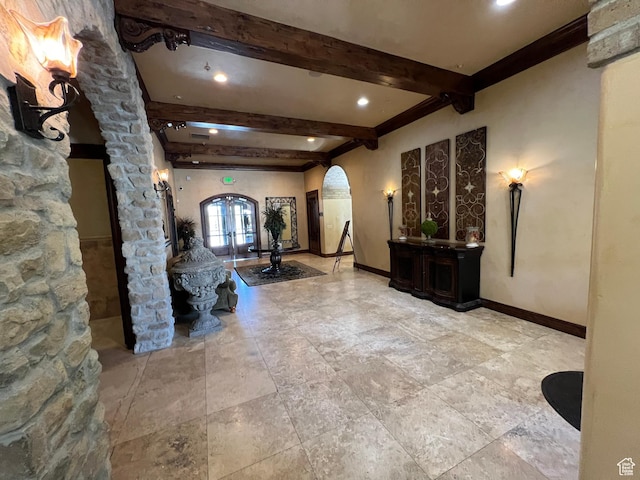 building lobby featuring beam ceiling and recessed lighting