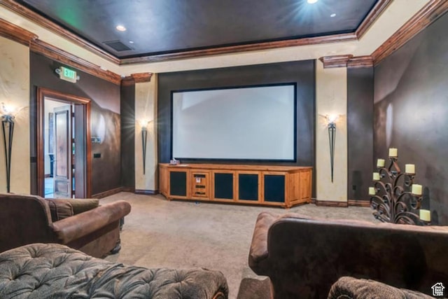carpeted home theater room featuring ornamental molding, baseboards, and a raised ceiling