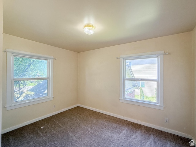 unfurnished room featuring carpet flooring, plenty of natural light, and baseboards