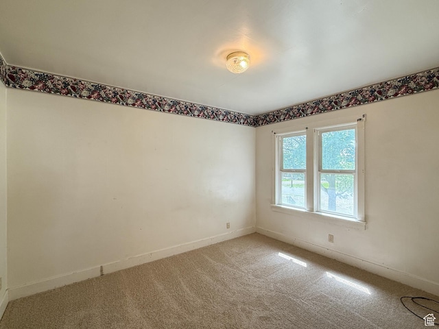 empty room with light carpet and baseboards