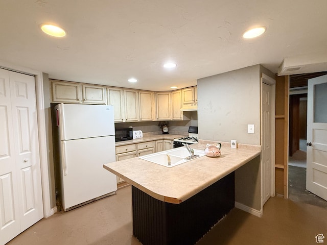 kitchen with white appliances, light countertops, recessed lighting, a peninsula, and concrete floors