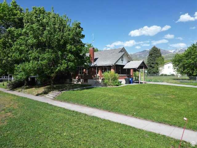 view of front of house featuring covered porch, a mountain view, and a chimney