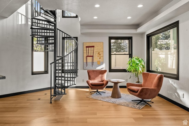 living area with wood finished floors, stairs, recessed lighting, and baseboards