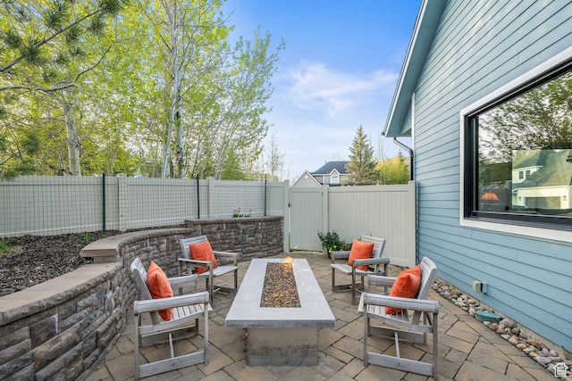 view of patio / terrace featuring an outdoor fire pit and a fenced backyard