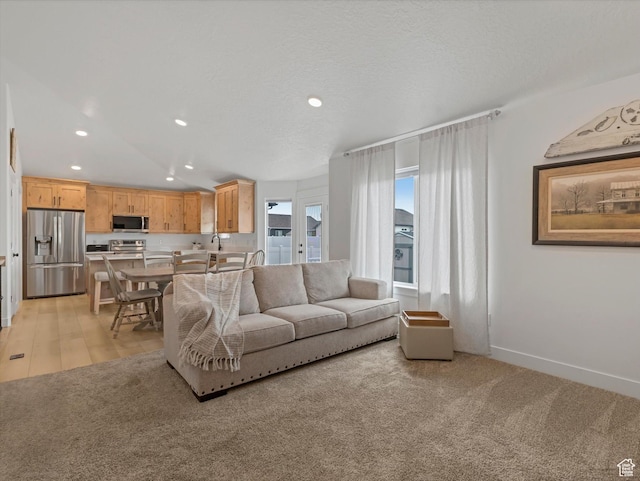 1245 N Clemente Way, Tooele, UT 84074 - living room with recessed lighting, light colored carpet, and baseboards