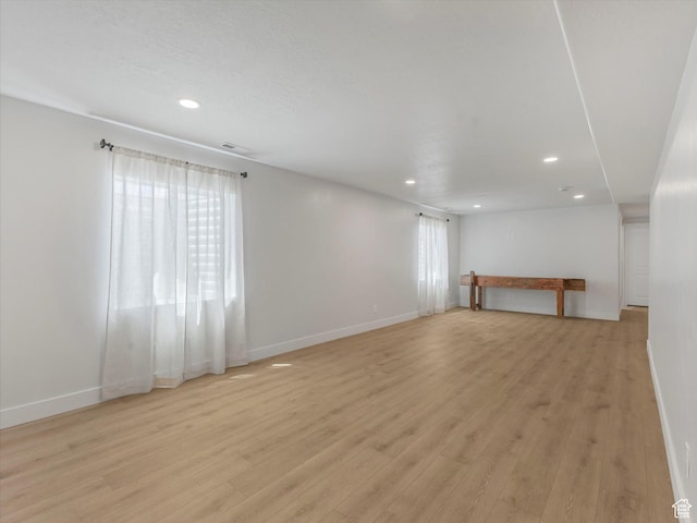 1245 N Clemente Way, Tooele, UT 84074 - unfurnished living room with baseboards, recessed lighting, and light wood-style floors