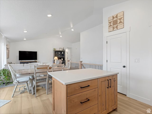 1245 N Clemente Way, Tooele, UT 84074 - kitchen with light wood-style floors, lofted ceiling, a kitchen island, recessed lighting, and light countertops