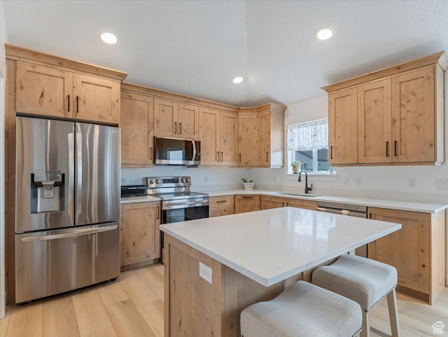 1245 N Clemente Way, Tooele, UT 84074 - kitchen with stainless steel appliances, a sink, light brown cabinetry, a breakfast bar, and light countertops