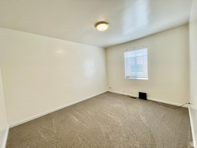 carpeted empty room with baseboards