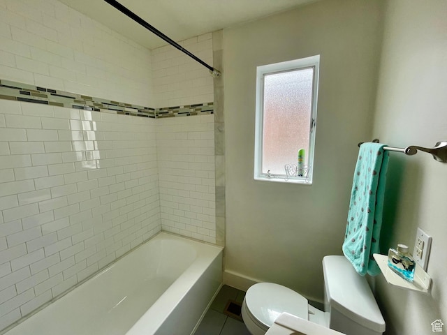 bathroom with toilet, baseboards, bathtub / shower combination, and tile patterned floors