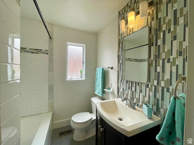 full bath with toilet, tile patterned flooring, vanity, baseboards, and bathtub / shower combination