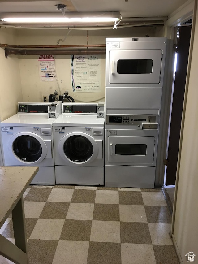 community laundry room featuring light flooring and stacked washer / drying machine