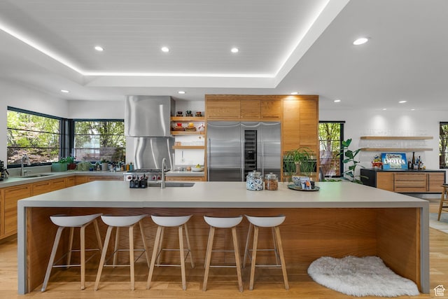 1863 E Hubbard Ave, Salt Lake City, UT 84108 - kitchen with built in refrigerator, a sink, a tray ceiling, recessed lighting, and a spacious island