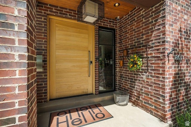 1863 E Hubbard Ave, Salt Lake City, UT 84108 - view of exterior entry with brick siding and a security system
