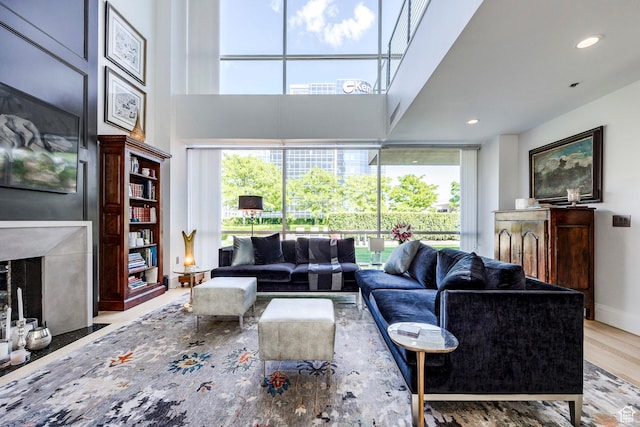 268 S State St E Unit 417, Salt Lake City, UT 84111 - living room with wood finished floors, plenty of natural light, a high ceiling, recessed lighting, and a fireplace