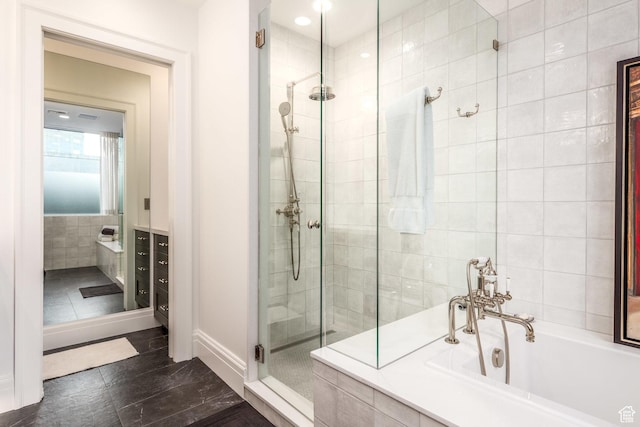 268 S State St E Unit 417, Salt Lake City, UT 84111 - bathroom with a shower stall, a bath, tile walls, and tile patterned floors