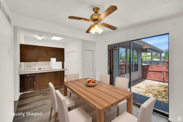 dining room with light wood-type flooring and ceiling fan
