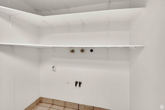 laundry room with hookup for an electric dryer, hookup for a washing machine, gas dryer hookup, light tile patterned floors, and baseboards