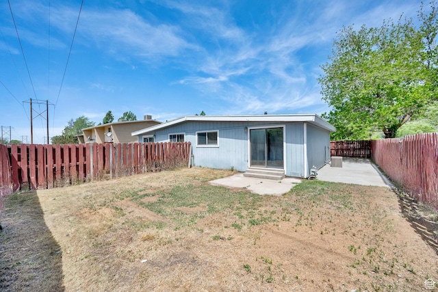 back of house with a fenced backyard, a patio area, and entry steps