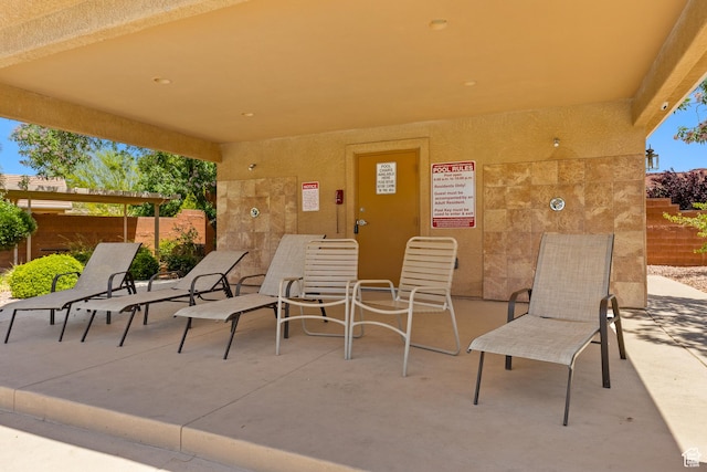 view of patio featuring fence