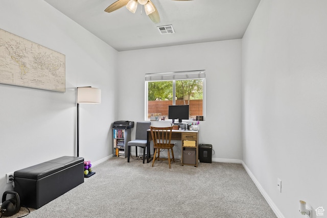 carpeted office space with ceiling fan and baseboards
