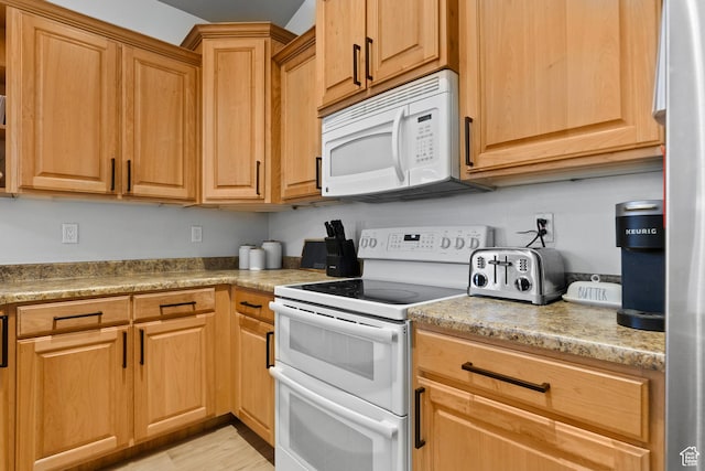 kitchen featuring white appliances and light wood-style flooring