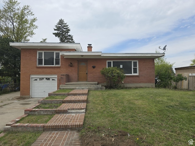 443 N 450 E, Orem, UT 84097 - tri-level home with a garage, driveway, brick siding, and a chimney