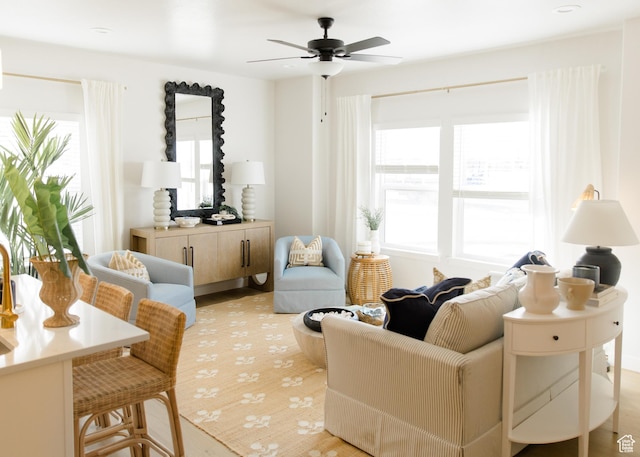 living area featuring plenty of natural light and a ceiling fan
