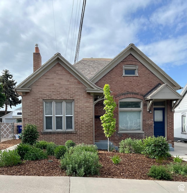 1318 E 300 S, Salt Lake City, UT 84102 - view of front of home featuring brick siding, a chimney, and fence
