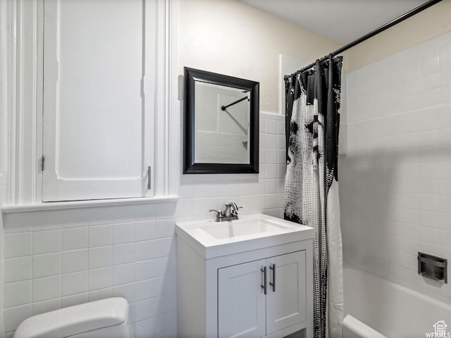 1318 E 300 S, Salt Lake City, UT 84102 - bathroom with tile walls, vanity, shower / bathtub combination with curtain, and toilet