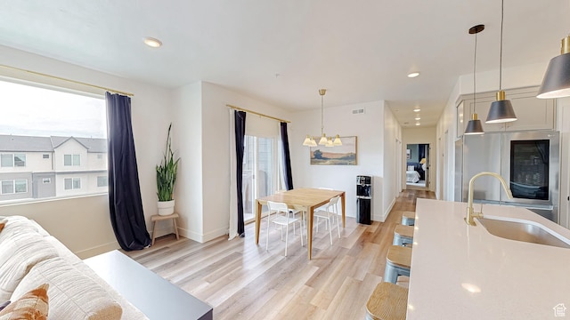 376 S 1080 W Unit 301, American Fork, UT 84003 - living area with light wood-style flooring, a chandelier, baseboards, and recessed lighting