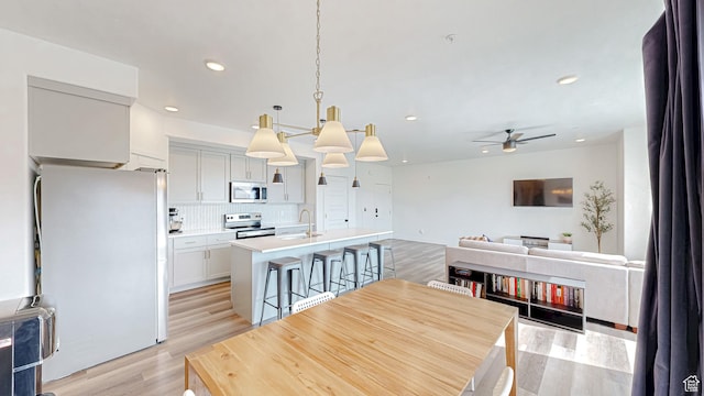 376 S 1080 W Unit 301, American Fork, UT 84003 - dining room featuring light wood-type flooring, a ceiling fan, and recessed lighting