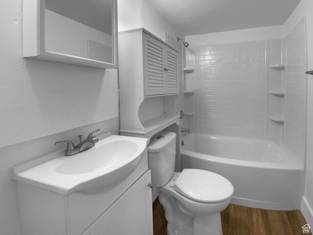 2987 S Eucalyptus Way, West Valley City, UT 84119 - bathroom featuring wood finished floors, toilet, vanity, and bathtub / shower combination