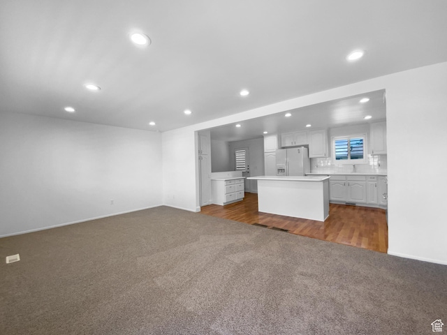 2987 S Eucalyptus Way, West Valley City, UT 84119 - unfurnished living room featuring dark carpet, recessed lighting, and baseboards
