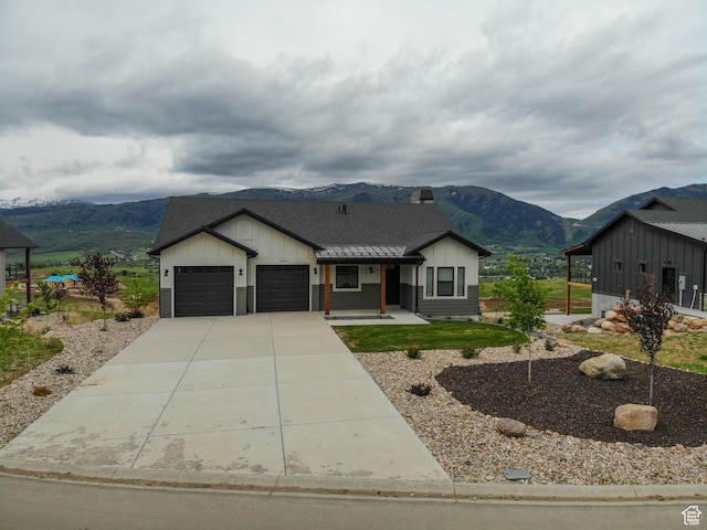 4491 N Seven Bridges Rd, Eden, UT 84310 - modern inspired farmhouse featuring board and batten siding, a mountain view, a garage, concrete driveway, and a shingled roof