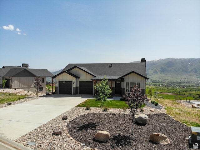 4491 N Seven Bridges Rd, Eden, UT 84310 - modern farmhouse style home featuring board and batten siding, concrete driveway, an attached garage, roof with shingles, and a mountain view