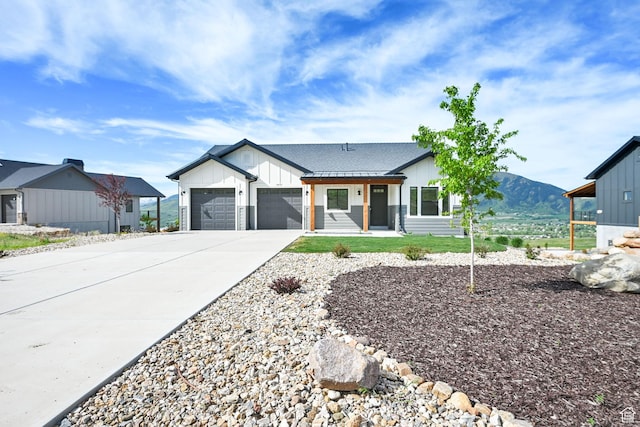 4491 N Seven Bridges Rd, Eden, UT 84310 - modern inspired farmhouse featuring board and batten siding, driveway, a garage, and a mountain view