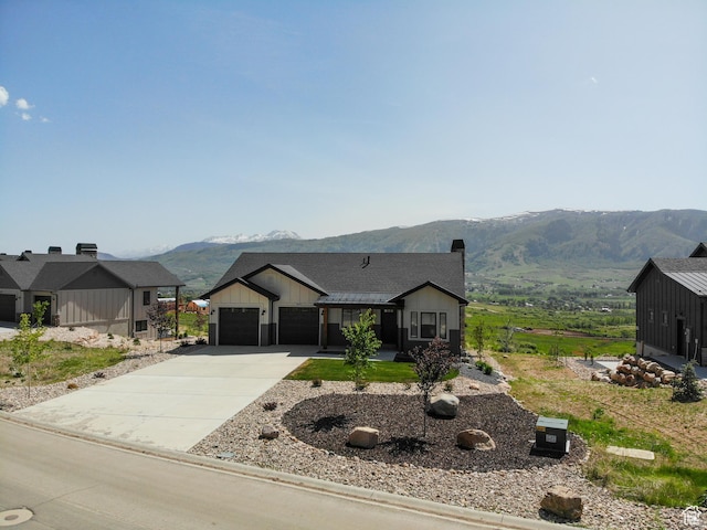 4491 N Seven Bridges Rd, Eden, UT 84310 - modern farmhouse with a mountain view, driveway, board and batten siding, a chimney, and a garage