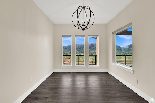 4491 N Seven Bridges Rd, Eden, UT 84310 - unfurnished dining area featuring a chandelier, baseboards, dark wood finished floors, and a mountain view