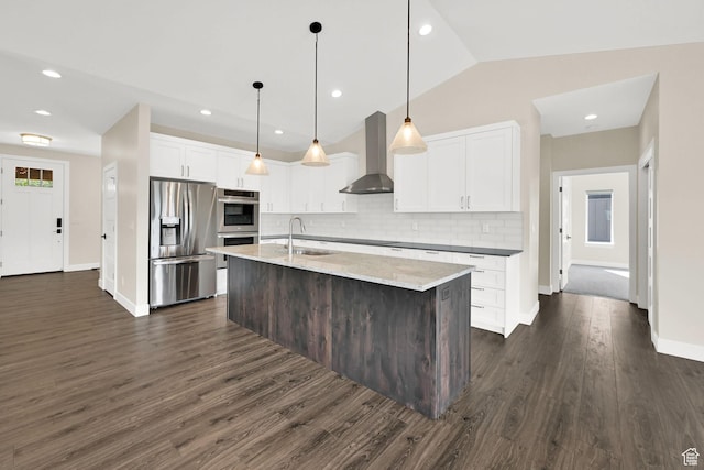 4491 N Seven Bridges Rd, Eden, UT 84310 - kitchen with stainless steel appliances, wall chimney exhaust hood, a sink, backsplash, and white cabinets