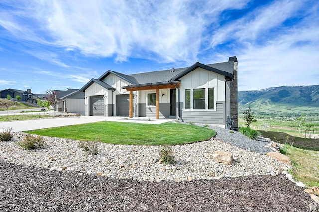 4491 N Seven Bridges Rd, Eden, UT 84310 - modern farmhouse featuring board and batten siding, an attached garage, concrete driveway, and a front lawn