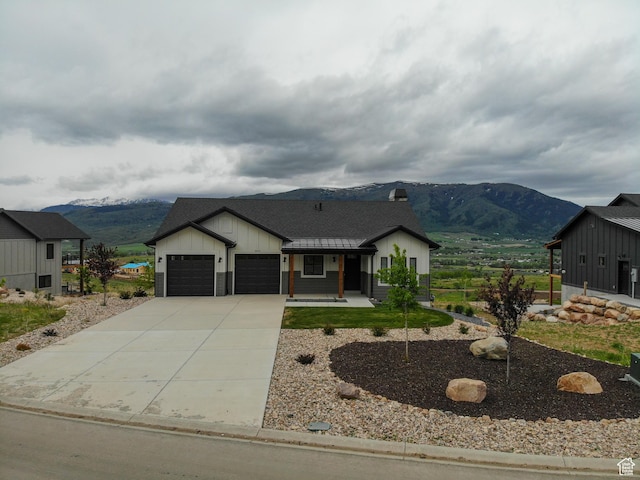 4491 N Seven Bridges Rd, Eden, UT 84310 - modern farmhouse with a mountain view, a garage, concrete driveway, board and batten siding, and a chimney
