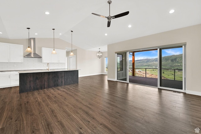 4491 N Seven Bridges Rd, Eden, UT 84310 - unfurnished living room featuring a ceiling fan, dark wood finished floors, recessed lighting, high vaulted ceiling, and a chandelier