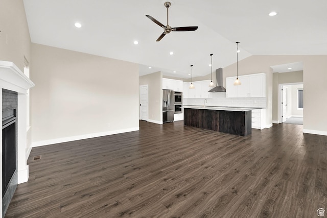 4491 N Seven Bridges Rd, Eden, UT 84310 - unfurnished living room featuring vaulted ceiling, a ceiling fan, a fireplace, dark wood-style floors, and baseboards