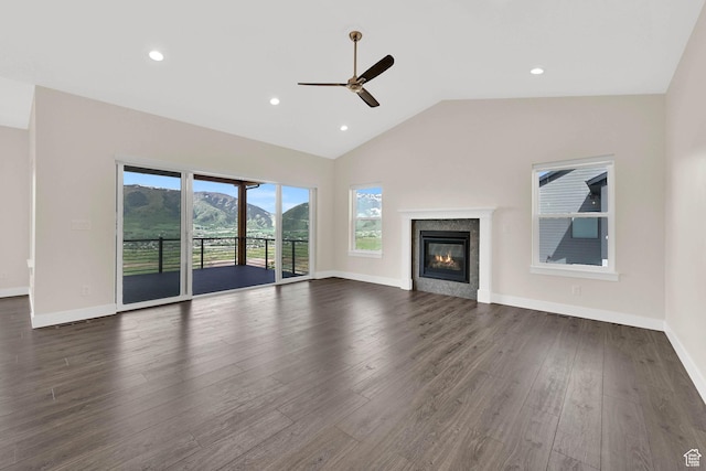 4491 N Seven Bridges Rd, Eden, UT 84310 - unfurnished living room featuring a ceiling fan, lofted ceiling, dark wood-type flooring, a glass covered fireplace, and baseboards